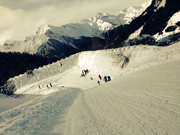 Tourists on snow covered mountain