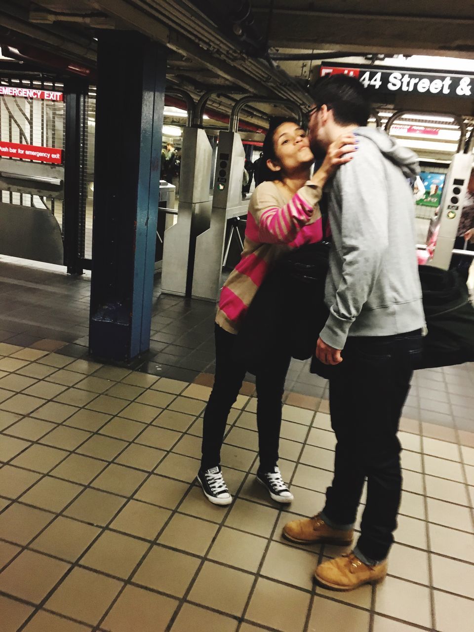 full length, lifestyles, casual clothing, leisure activity, standing, indoors, person, men, railroad station platform, rear view, public transportation, walking, front view, railroad station, togetherness, built structure