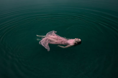 High angle view of woman swimming in lake