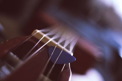 Close-up of hand playing guitar