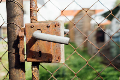 Close-up of padlock on fence