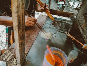 High angle view of man preparing food on table