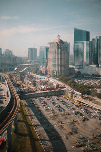 High angle view of road amidst buildings in city against sky