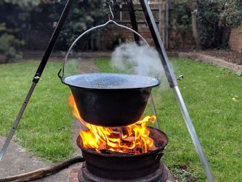 Container hanging on fire pit