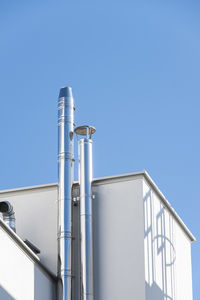 Low angle view of smoke stack against sky