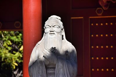 Statue of buddha against building