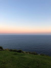 Scenic view of sea against clear sky during sunset