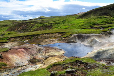 Scenic view of waterfall against sky