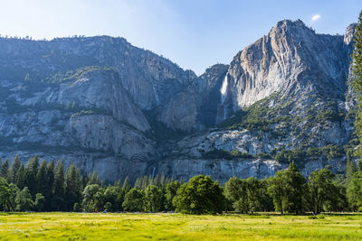 Scenic view of land and mountains against sky