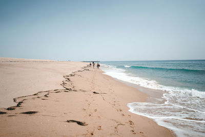 Scenic view of beach against clear sky