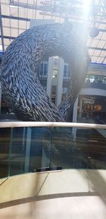 Reflection of buildings on glass window in city