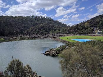 Scenic view of lake by trees against sky