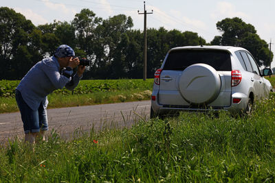 People looking at grassy field