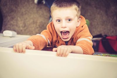 High angle portrait of playful boy screaming outdoors