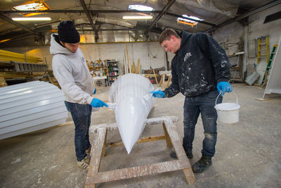 Side view of a man holding umbrella