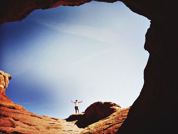 Low angle view of people on rock formation