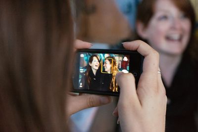 Woman photographing through smart phone