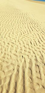 High angle view of footprints on sand at beach