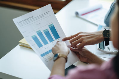 Midsection of business colleagues working on table