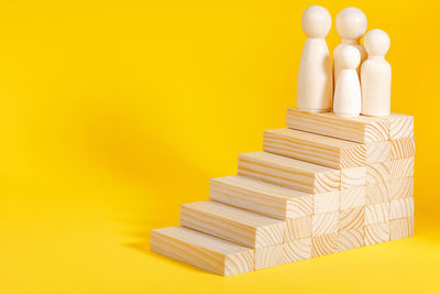 Close-up of toy blocks against yellow background