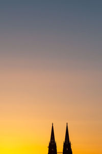 Silhouette of building against sky during sunset