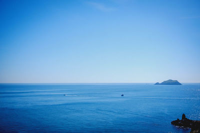 Scenic view of sea against clear blue sky