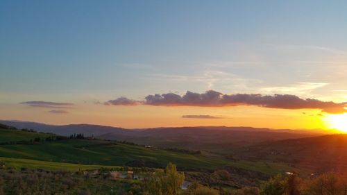 Scenic view of field against sky during sunset