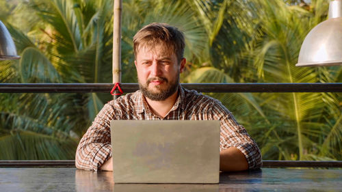 Portrait of man sitting on table