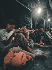 People sitting at music concert at night