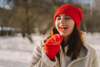 Happy valentines day. young woman posing with valentine's day heart shaped candies and lollipops