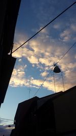 Low angle view of power lines against sky