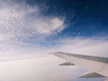 Low angle view of airplane wing against sky