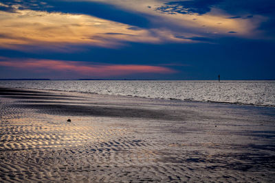 Scenic view of beach against sky during sunset