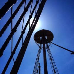 Low angle view of metallic structure against blue sky