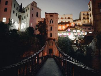 Low angle view of a footbridge and  buildings in city