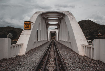 View of railroad tracks against cloudy sky