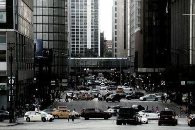 Cars on city street amidst buildings