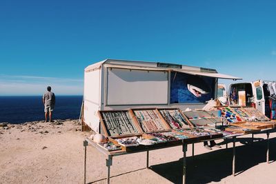 Lifeguard hut on beach against clear sky