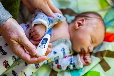 Midsection of mother and baby hands