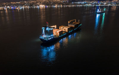 High angle view of illuminated harbor in city at night