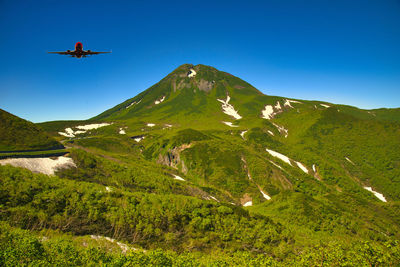 Scenic view of mountains against clear blue sky