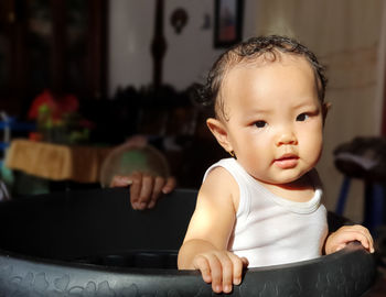 Portrait of cute boy sitting at home