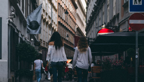 Rear view of people walking on street