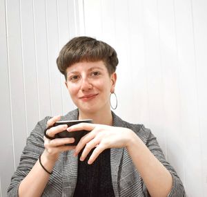 Portrait of smiling woman having coffee at home