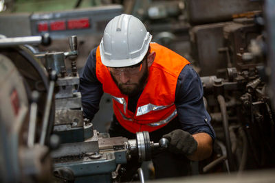 Rear view of man working in factory