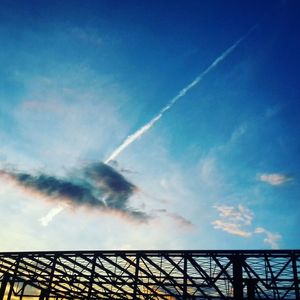 Low angle view of vapor trail against blue sky