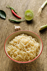 High angle view of noodles and vegetables on table