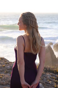 Young woman standing at beach