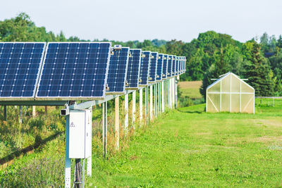 Solar panels in an agriculture green field in the countryside. solar power plant. blue solar panels