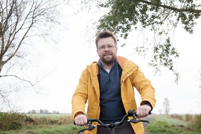 Portrait of man standing on field